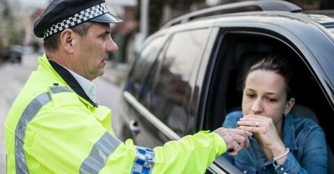 A driver taking a breath test at the roadside